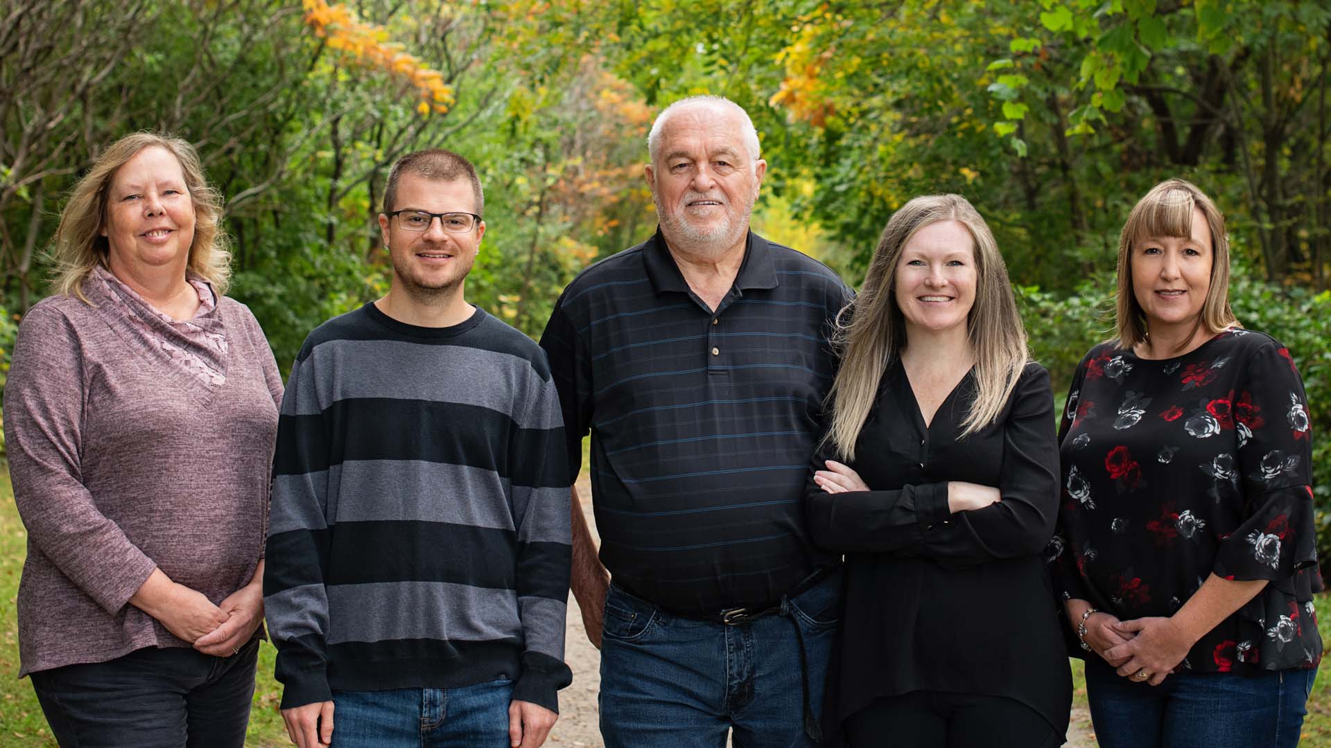 Group photo of the team with a natural green space background