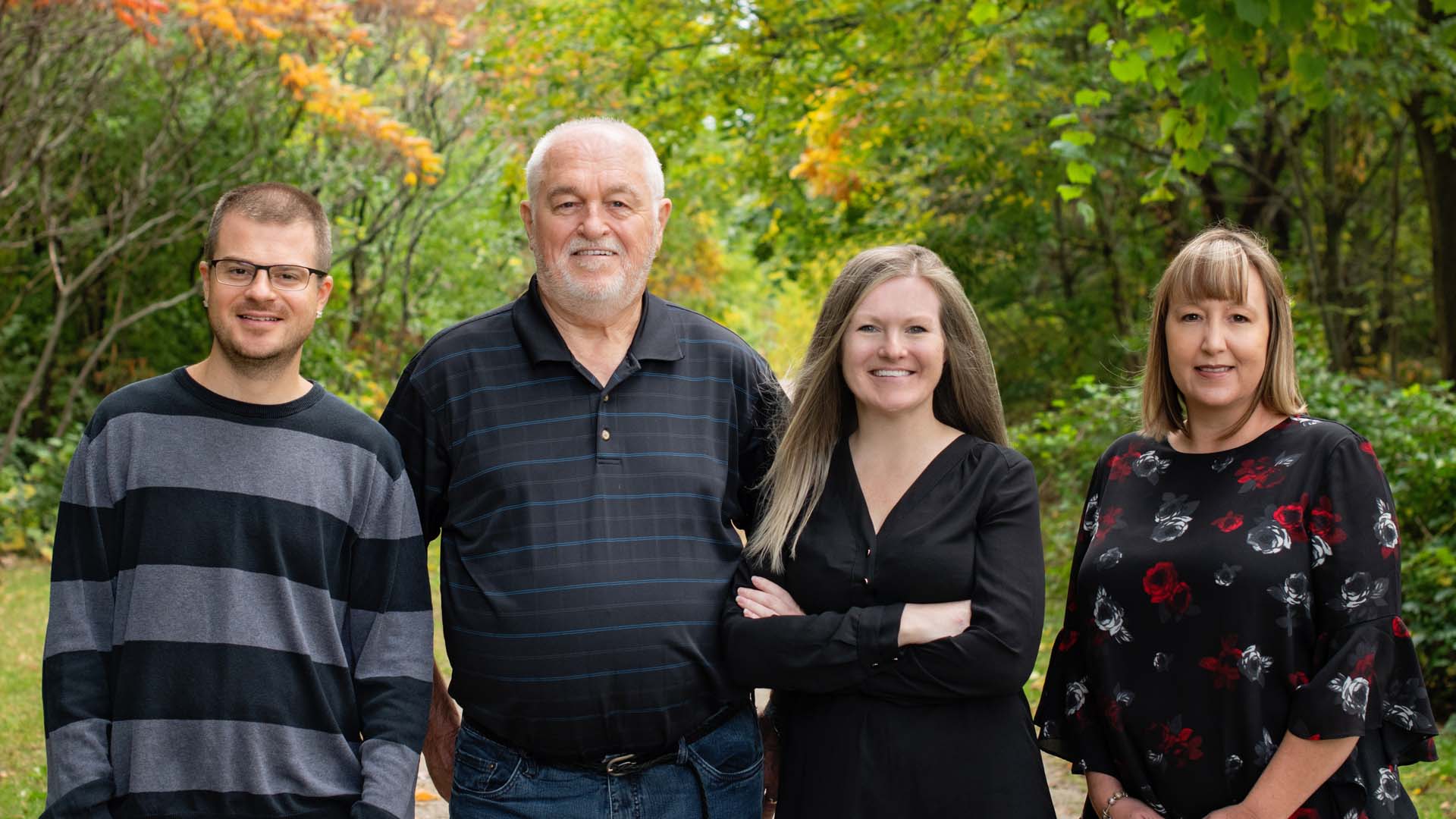 Group photo of the team with a natural green space background