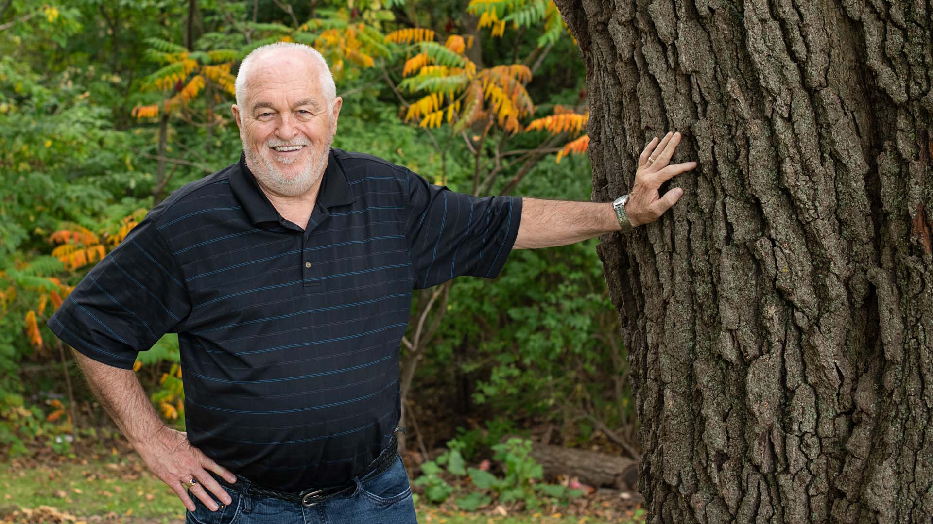 Steven Obranovich standing next to a tree in a park